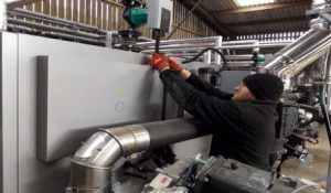 Engineer servicing biomass boiler